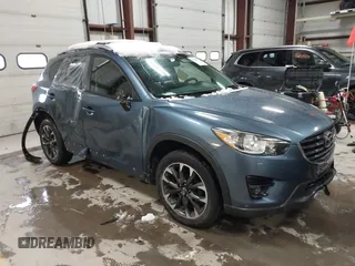 2016 Mazda CX-5 Grand Touring z VIN JM3KE4DY9G0714468, wystawiony jako IAAI lot #41860956 z przebiegiem 114 481 mil mil oraz . Historia ofert i sprzedaży dostępna na DreamBid. Obrazek 1.
