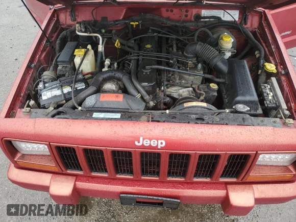 1999 Jeep Cherokee Sport with VIN 1J4FT68S1XL601799, listed as a Copart auction lot 83881844 with 203,572 mi miles and Salvage title. Bid and sale history available at DreamBid. Image 13.