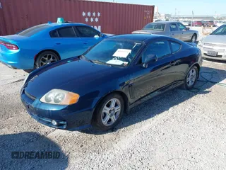 2003 Hyundai Tiburon GT z VIN KMHHN65FX3U076547, wystawiony jako IAAI lot #42015723 z przebiegiem 174 909 mil mil oraz . Historia ofert i sprzedaży dostępna na DreamBid. Obrazek 2.