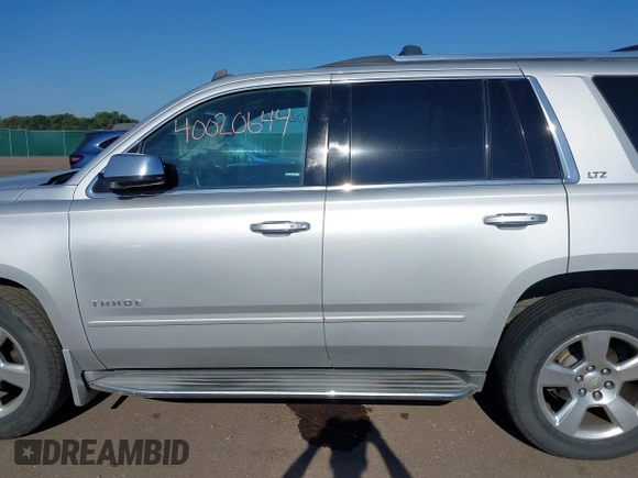 2015 Chevrolet Tahoe LTZ with VIN 1GNSKCKC5FR205739, listed as a IAAI auction lot 40020644 with 142,524 mi miles and . Bid and sale history available at DreamBid. Image 14.