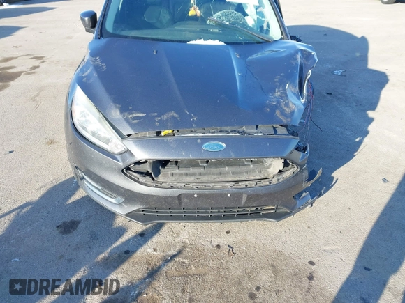 2015 Ford Focus Titanium z VIN 1FADP3N23FL368324, wystawiony jako IAAI lot #41387070 z przebiegiem Nie podano mil oraz . Historia ofert i sprzedaży dostępna na DreamBid. Obrazek 13.