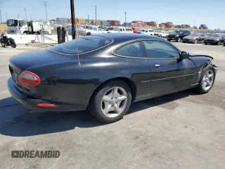 1997 Jaguar XK with VIN SAJGX5740VC014035, listed as a Copart auction lot 53066215 with 140,692 mi miles and Salvage Title. Bid and sale history available at DreamBid. Image 3.