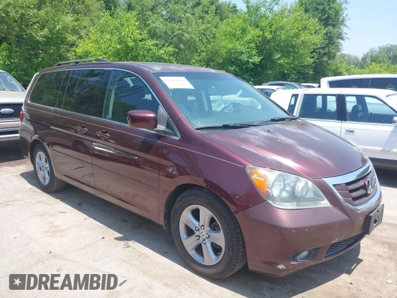 2010 Honda Odyssey Touring z VIN 5FNRL3H92AB010292, wystawiony jako IAAI lot #42469216 z przebiegiem 188 921 mil mil oraz . Historia ofert i sprzedaży dostępna na DreamBid. Obrazek 1.