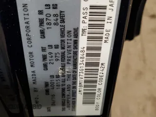 2016 Mazda 3 i Touring z VIN JM1BM1V73G1348484, wystawiony jako Copart lot #60684625 z przebiegiem 58 770 mil mil oraz Szkoda całkowita • Salvage title. Historia ofert i sprzedaży dostępna na DreamBid. Obrazek 12.