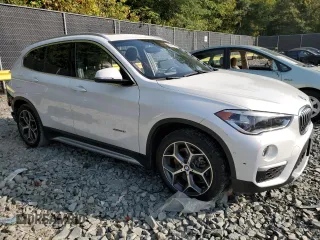 2017 BMW X1 xDrive28i with VIN WBXHT3C33H5F70208, listed as a Copart auction lot 67999764 with 130,341 mi miles and Salvage Title. Bid and sale history available at carsss.com. Image 4.