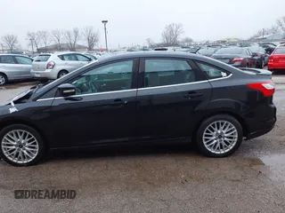 2014 Ford Focus Titanium with VIN 1FADP3J25EL310199, listed as a IAAI auction lot 40682901 with 84,885 mi miles and . Bid and sale history available at DreamBid. Image 13.