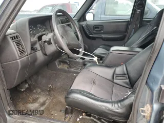 1999 Jeep Cherokee Sport with VIN 1J4FF68S4XL567848, listed as a Copart auction lot 43222045 with 280,178 mi miles and Salvage title. Bid and sale history available at DreamBid. Image 7.