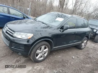 2012 Volkswagen Touareg Sport with VIN WVGFK9BP7CD002243, listed as a IAAI auction lot 41863765 with 136,231 mi miles and . Bid and sale history available at DreamBid. Image 2.