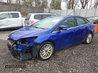 2014 Ford Focus Titanium with VIN 1FADP3J28EL240911, listed as a IAAI auction lot 42082812 with 144,625 mi miles. Bid and sale history available at carsss.com. Image 2.