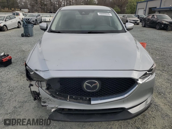 2021 Mazda CX-5 Touring with VIN JM3KFACM2M0451083, listed as a Copart auction lot 49999935 with 59,927 mi miles and Salvage Title. Bid and sale history available at carsss.com. Image 5.