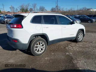 2015 Jeep Cherokee Latitude with VIN 1C4PJMCB3FW734573, listed as a IAAI auction lot 41825561 with 141,250 mi miles. Bid and sale history available at carsss.com. Image 4.