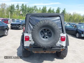 2003 Jeep Wrangler Sport z VIN 1J4FA49S73P302278, wystawiony jako IAAI lot #42219582 z przebiegiem 129 089 mil mil oraz . Historia ofert i sprzedaży dostępna na DreamBid. Obrazek 16.