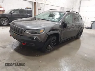2022 Jeep Cherokee Trailhawk z VIN 1C4PJMBX9ND514703, wystawiony jako IAAI lot #41761037 z przebiegiem 38 499 mil mil oraz . Historia ofert i sprzedaży dostępna na DreamBid. Obrazek 2.
