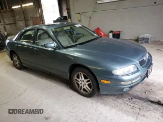 2000 Mazda Millenia z VIN JM1TA2212Y1610919, wystawiony jako Copart lot #80375014 z przebiegiem 127 938 mil mil oraz Szkody całkowita. Historia ofert i sprzedaży dostępna na DreamBid. Obrazek 4.