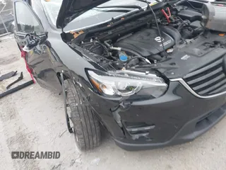 2016 Mazda CX-5 Grand Touring with VIN JM3KE4DY1G0685449, listed as a IAAI auction lot 41162840 with 134,525 mi miles. Bid and sale history available at carsss.com. Image 6.
