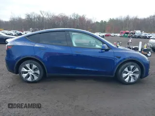 2023 Tesla Model Y Long Range z VIN 7SAYGDEE2PF694974, wystawiony jako IAAI lot #41814582 z przebiegiem 31 726 mil mil oraz . Historia ofert i sprzedaży dostępna na DreamBid. Obrazek 13.
