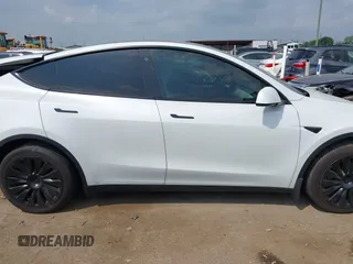 2023 Tesla Model Y Long Range with VIN 7SAYGAEEXPF776370, listed as a IAAI auction lot 42127512 with 27,120 mi miles and . Bid and sale history available at DreamBid. Image 14.