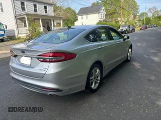 2018 Ford Fusion SE z VIN 3FA6P0LU9JR208728, wystawiony jako Copart lot #56345445 z przebiegiem 183 982 mil mil oraz Czysty tytuł • Clean title. Historia ofert i sprzedaży dostępna na DreamBid. Obrazek 4.