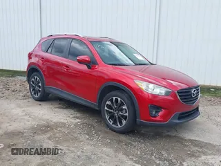 2016 Mazda CX-5 Grand Touring z VIN JM3KE2DY6G0693678, wystawiony jako IAAI lot #42443247 z przebiegiem 127 620 mil mil oraz . Historia ofert i sprzedaży dostępna na DreamBid. Obrazek 1.