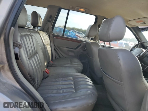 1999 Jeep Grand Cherokee Limited with VIN 1J4G268S7XC668348, listed as a Copart auction lot 77824084 with 165,779 mi miles and Salvage title. Bid and sale history available at DreamBid. Image 11.