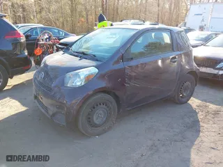 2014 Scion iQ with VIN JTNJJXB09EJ030215, listed as a IAAI auction lot 41329143 with 126,954 mi miles. Bid and sale history available at carsss.com. Image 2.
