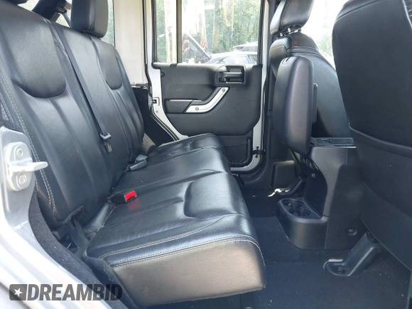 2013 Jeep Wrangler Unlimited Sahara with VIN 1C4BJWEG4DL666930, listed as a IAAI auction lot 42310569 with 206,577 mi miles and . Bid and sale history available at DreamBid. Image 8.
