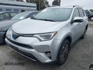 2016 Toyota RAV4 Hybrid XLE with VIN JTMRJREVXGD029019, listed as a IAAI auction lot 42021530 with 74,400 mi miles. Bid and sale history available at carsss.com. Image 2.