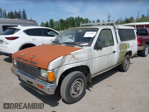 1987 Nissan Hardbody E z VIN JN6ND11S1HW047821, wystawiony jako IAAI lot #42210912 z przebiegiem 162 721 mil mil oraz . Historia ofert i sprzedaży dostępna na DreamBid. Obrazek 2.