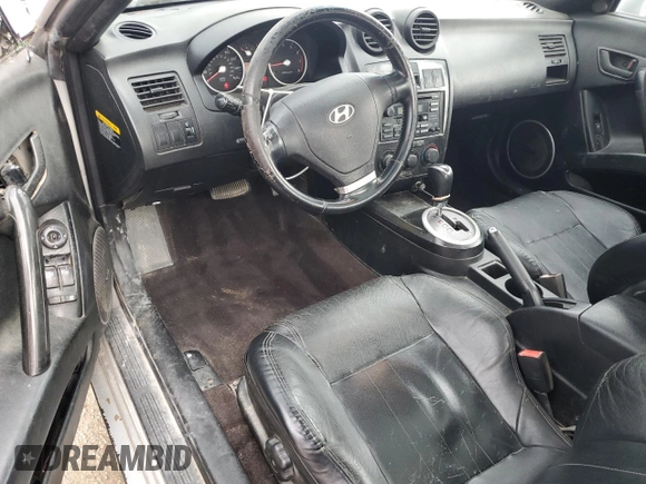 2003 Hyundai Tiburon GT z VIN KMHHN65F13U013420, wystawiony jako Copart lot #51234495 z przebiegiem 230 612 mil mil oraz Szkoda całkowita • Salvage title. Historia ofert i sprzedaży dostępna na DreamBid. Obrazek 8.
