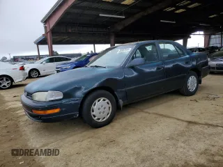 1992 Toyota Camry z VIN 4T1SK11E0NU098624, wystawiony jako Copart lot #85957544 z przebiegiem 78 319 mil mil oraz Czysty tytuł • Clean title. Historia ofert i sprzedaży dostępna na DreamBid. Obrazek 1.