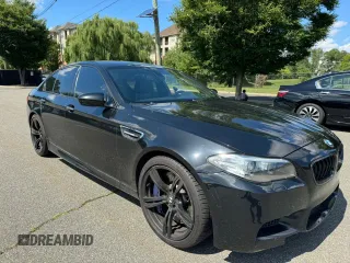 2015 BMW M5 with VIN WBSFV9C56FD595096, listed as a Copart auction lot 76574074 with 61,779 mi miles and Salvage Title. Bid and sale history available at carsss.com. Image 1.