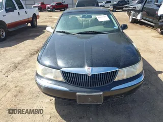 1999 Lincoln Continental with VIN 1LNHM97V8XY686521, listed as a IAAI auction lot 41681027 with 144,407 mi miles. Bid and sale history available at carsss.com. Image 6.