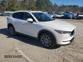 2021 Mazda CX-5 Grand Touring with VIN JM3KFBDM0M1440565, listed as a Copart auction lot 87089404 with 34,607 mi miles and Salvage Title. Bid and sale history available at carsss.com. Image 4.