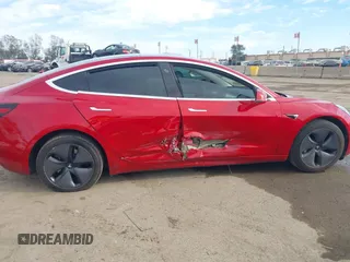 2020 Tesla Model 3 Standard Range Plus with VIN 5YJ3E1EA9LF718027, listed as a IAAI auction lot 41679320 with 68,987 mi miles. Bid and sale history available at carsss.com. Image 6.