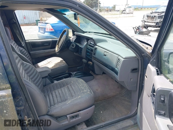 1994 Jeep Grand Cherokee Laredo z VIN 1J4GZ58Y2RC320793, wystawiony jako IAAI lot #42781115 z przebiegiem 275 518 mil mil oraz . Historia ofert i sprzedaży dostępna na DreamBid. Obrazek 5.