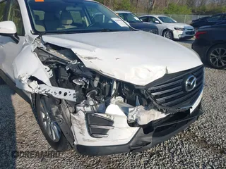 2016 Mazda CX-5 Sport with VIN JM3KE2BY2G0819604, listed as a IAAI auction lot 42059846 with 124,911 mi miles. Bid and sale history available at carsss.com. Image 6.