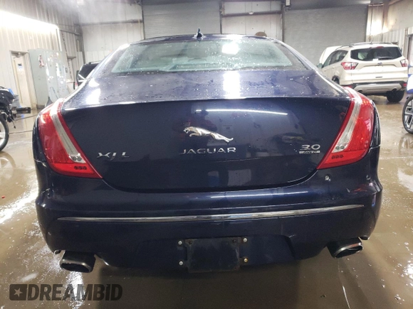 2014 Jaguar XJ Portfolio with VIN SAJWJ2GD5E8V69562, listed as a Copart auction lot 87737195 with 100,525 mi miles and Salvage title. Bid and sale history available at DreamBid. Image 6.