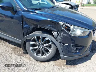 2016 Mazda CX-5 Grand Touring with VIN JM3KE4DY5G0681369, listed as a IAAI auction lot 42102805 with 128,182 mi miles and . Bid and sale history available at DreamBid. Image 6.