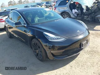 2018 Tesla Model 3 Long Range Battery with VIN 5YJ3E1EA0JF056979, listed as a IAAI auction lot 41865849 with 97,319 mi miles. Bid and sale history available at carsss.com. Image 1.