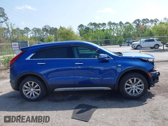 2023 Cadillac XT4 FWD Premium Luxury z VIN 1GYFZCR43PF104796, wystawiony jako IAAI lot #41931695 z przebiegiem 12 666 mil mil oraz . Historia ofert i sprzedaży dostępna na DreamBid. Obrazek 13.
