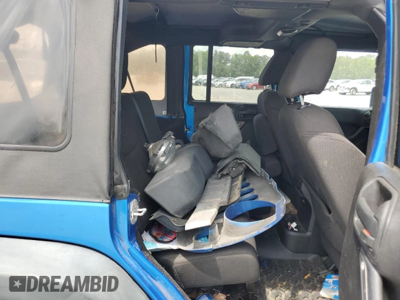 2015 Jeep Wrangler Unlimited Willys Wheeler with VIN 1C4BJWDG4FL611656, listed as a Copart auction lot 54010395 with 129,797 mi miles and Salvage Title. Bid and sale history available at DreamBid. Image 11.