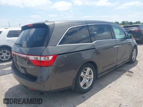 2012 Honda Odyssey Touring with VIN 5FNRL5H90CB088536, listed as a IAAI auction lot 42102008 with 283,350 mi miles and . Bid and sale history available at DreamBid. Image 4.