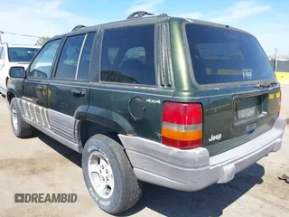 1996 Jeep Grand Cherokee Laredo with VIN 1J4GZ58S7TC280276, listed as a IAAI auction lot 42120454 with 230,617 mi miles. Bid and sale history available at carsss.com. Image 3.