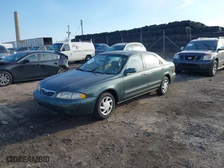 1999 Mazda 626 ES with VIN 1YVGF22C0X5835930, listed as a IAAI auction lot 41666820 with 93,973 mi miles. Bid and sale history available at carsss.com. Image 2.
