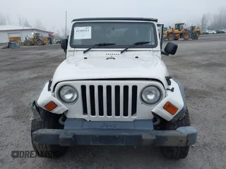 2006 Jeep Wrangler Sport Right Hand Drive with VIN 1J4F449S16P709895, listed as a IAAI auction lot 41349311 with 157,125 mi miles. Bid and sale history available at carsss.com. Image 12.