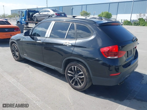 2015 BMW X1 sDrive28i with VIN WBAVM1C59FVW57928, listed as a IAAI auction lot 42056452 with 115,411 mi miles. Bid and sale history available at carsss.com. Image 3.