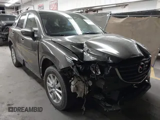 2016 Mazda CX-5 Touring z VIN JM3KE2CY8G0805656, wystawiony jako IAAI lot #42111609 z przebiegiem 76 519 mil mil oraz . Historia ofert i sprzedaży dostępna na DreamBid. Obrazek 1.