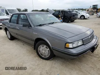 1992 Oldsmobile Cutlass z VIN 1G3AL54N4N6438104, wystawiony jako Copart lot #74415204 z przebiegiem 118 459 mil mil oraz Szkody całkowita. Historia ofert i sprzedaży dostępna na DreamBid. Obrazek 4.