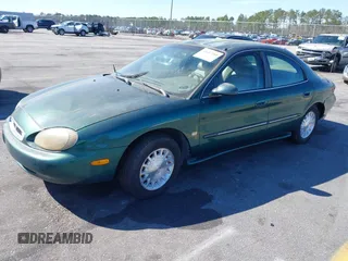 1999 Mercury Sable LS z VIN 1MEFM53S7XA612899, wystawiony jako IAAI lot #41687188 z przebiegiem 155 128 mil mil oraz . Historia ofert i sprzedaży dostępna na DreamBid. Obrazek 2.