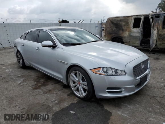 2014 Jaguar XJ Portfolio with VIN SAJWJ2GD2E8V62696, listed as a Copart auction lot 76620494 with 85,487 mi miles and Salvage title. Bid and sale history available at DreamBid. Image 4.